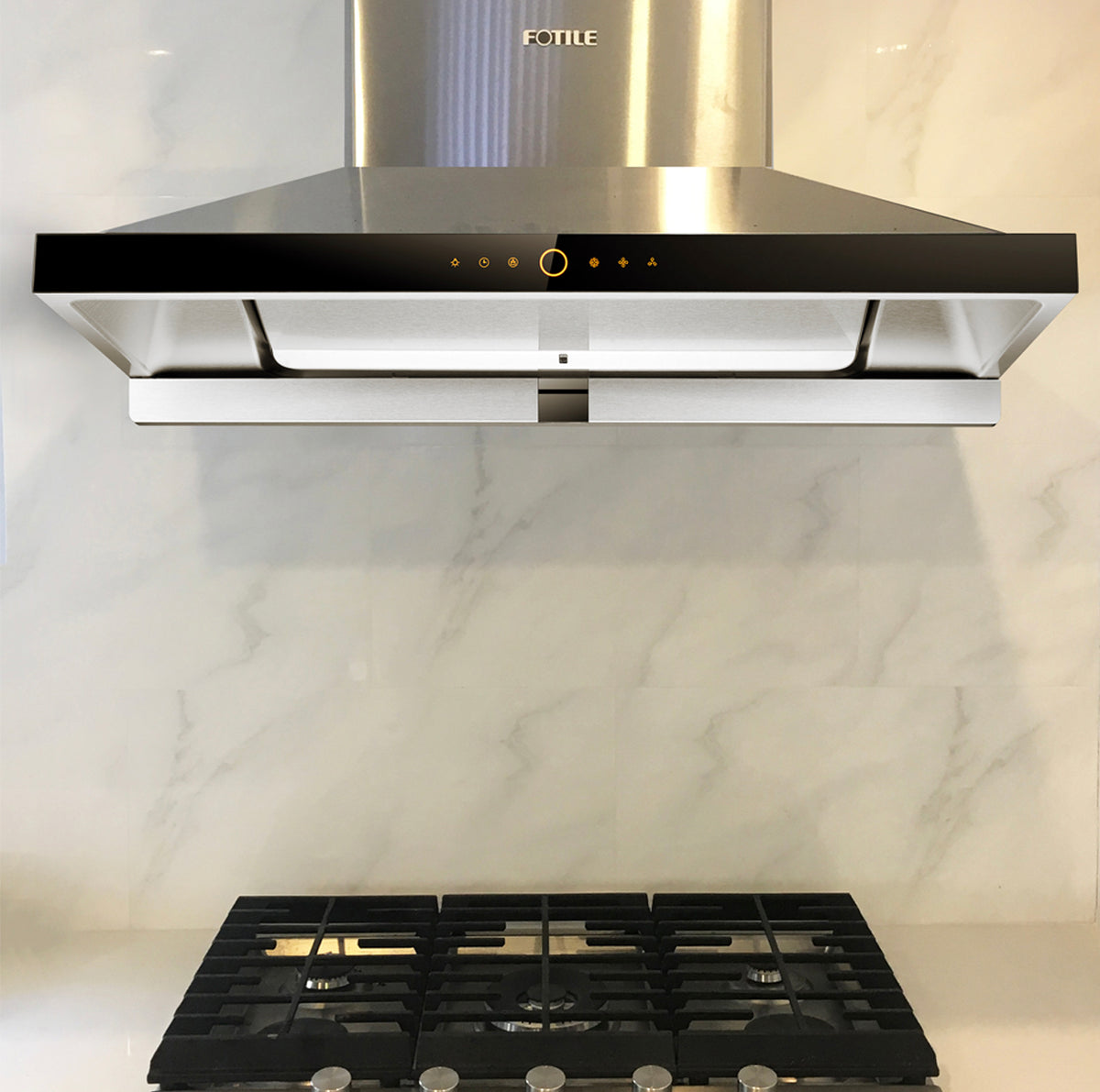 Stainless Steel EMS9026 36-inch range hood mounted above a black stove on a marble wall.