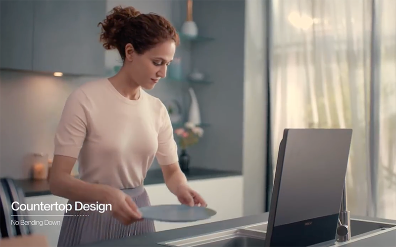 Woman removing a dish from the SD2F-P1X dishwasher.